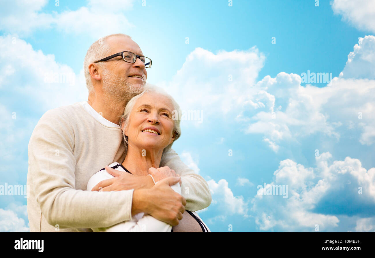 happy senior couple over blue sky and clouds Stock Photo - Alamy