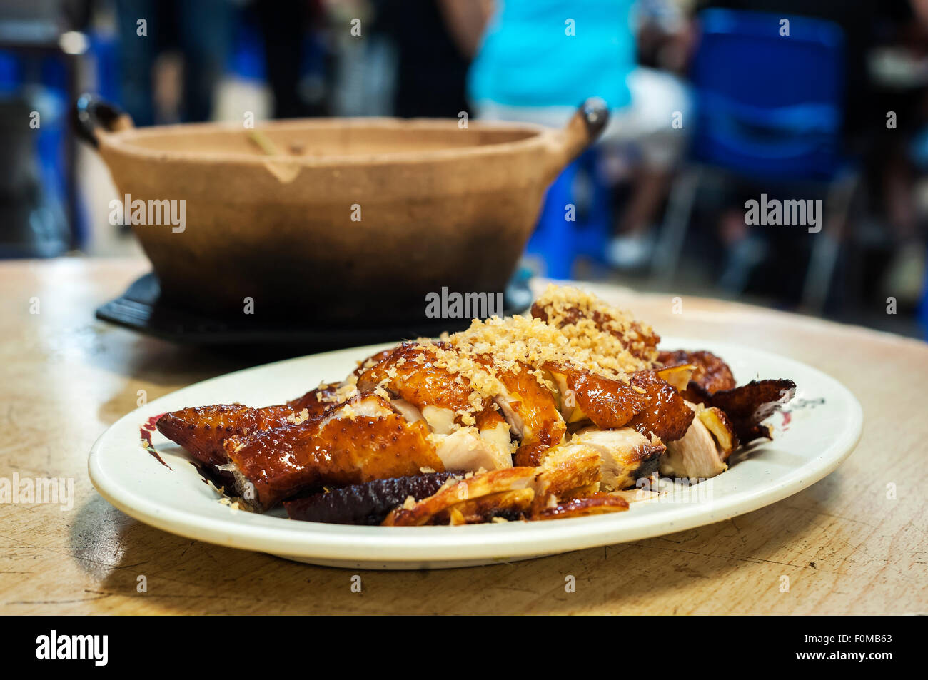Classic roasted chicken topped with garlic served at a Hong Kong restaurant Stock Photo