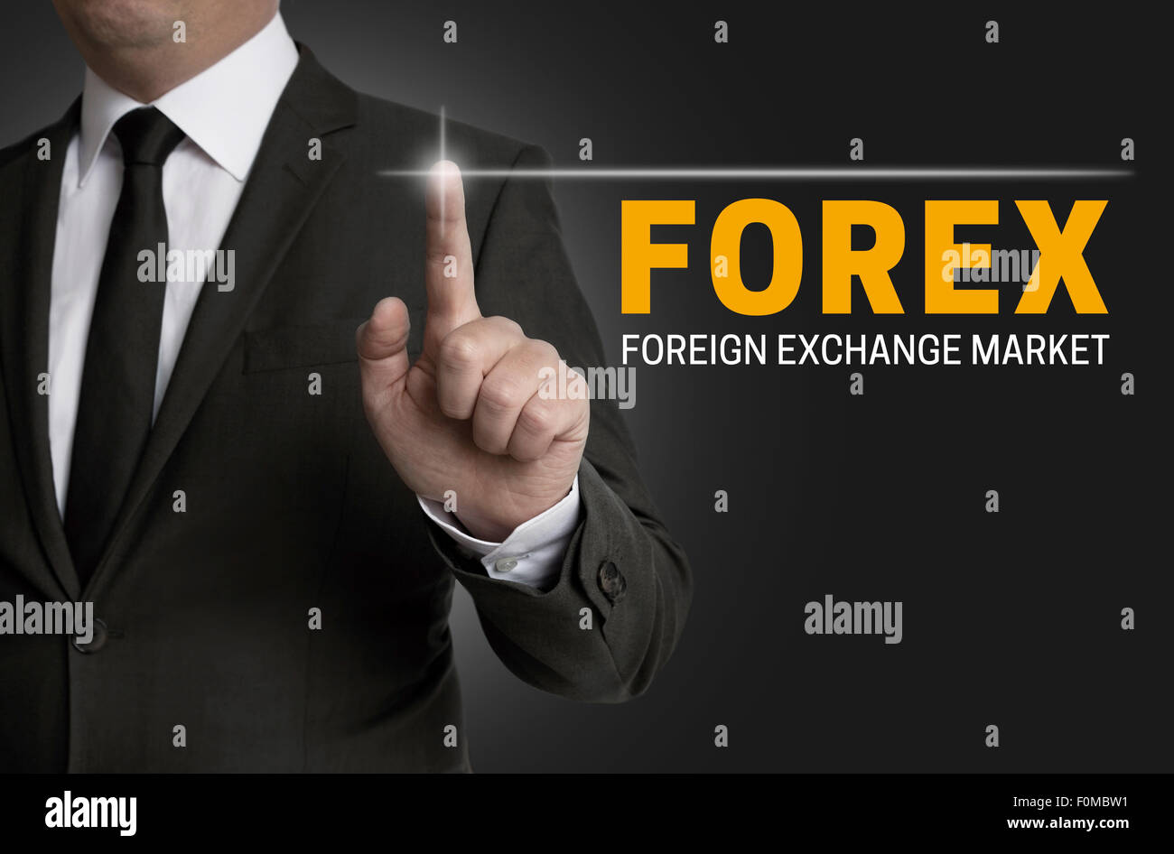 Forex touchscreen is operated by businessman. Stock Photo