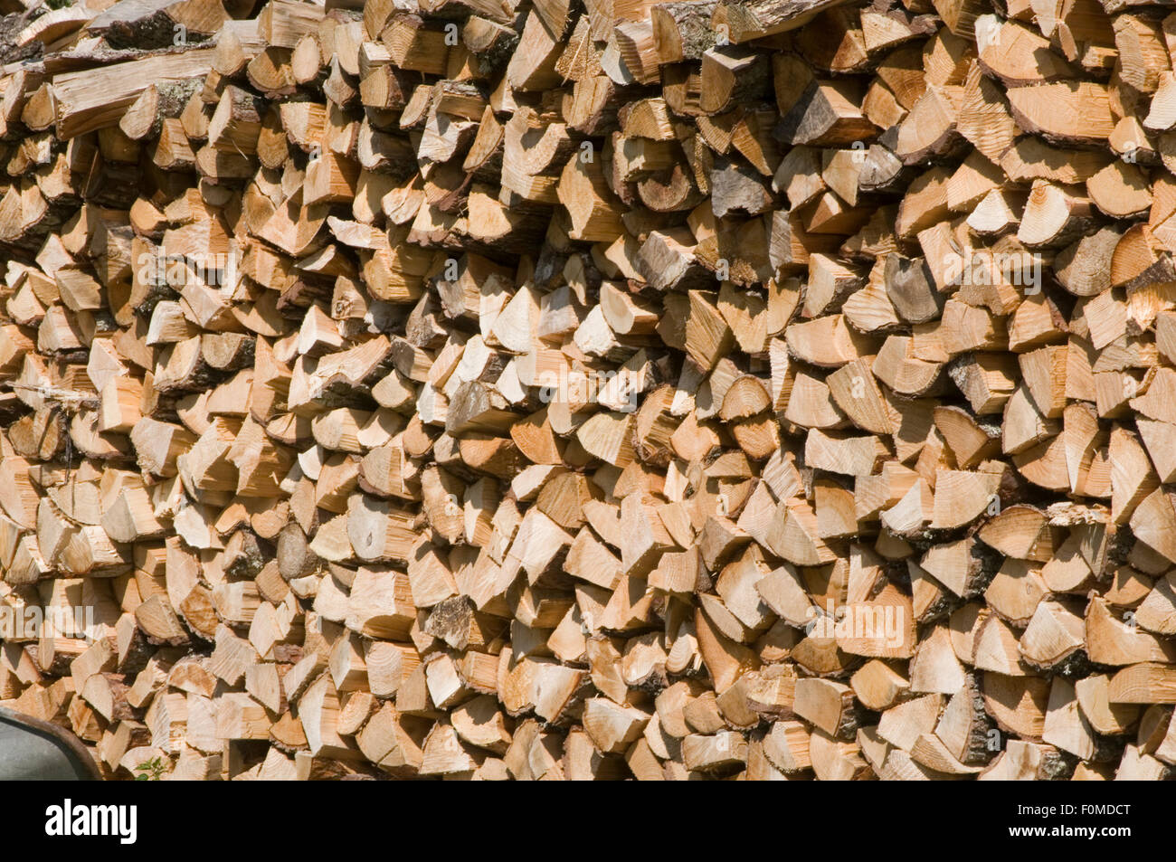 chopped fire wood firewood chopping cutting stacked stacking split branches dry drying seasoning for the winter store stored car Stock Photo