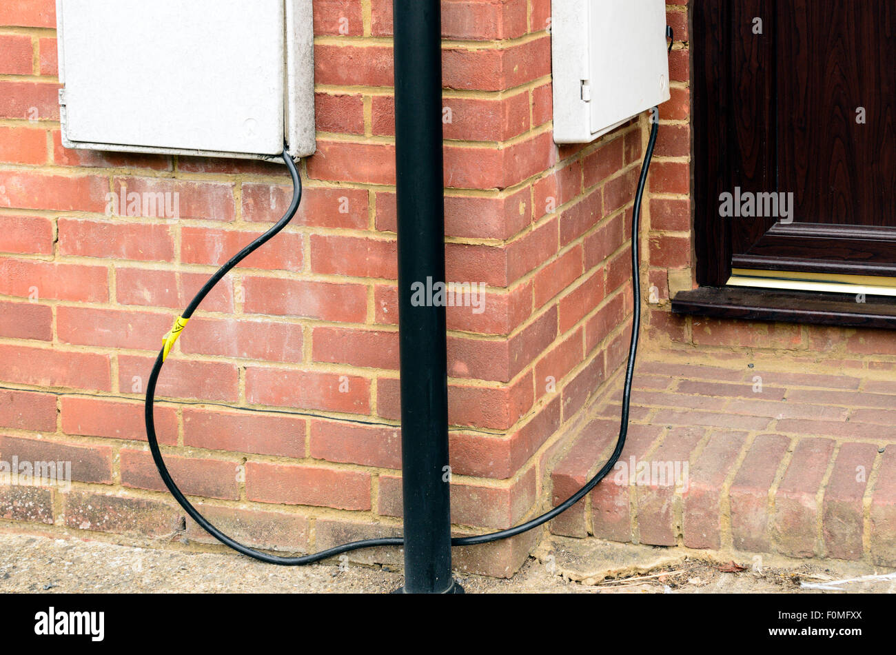 Mock up of what it might look like when Electricity Theft takes place. Two Electric Meter boxes are shown as if 'linked'. Stock Photo