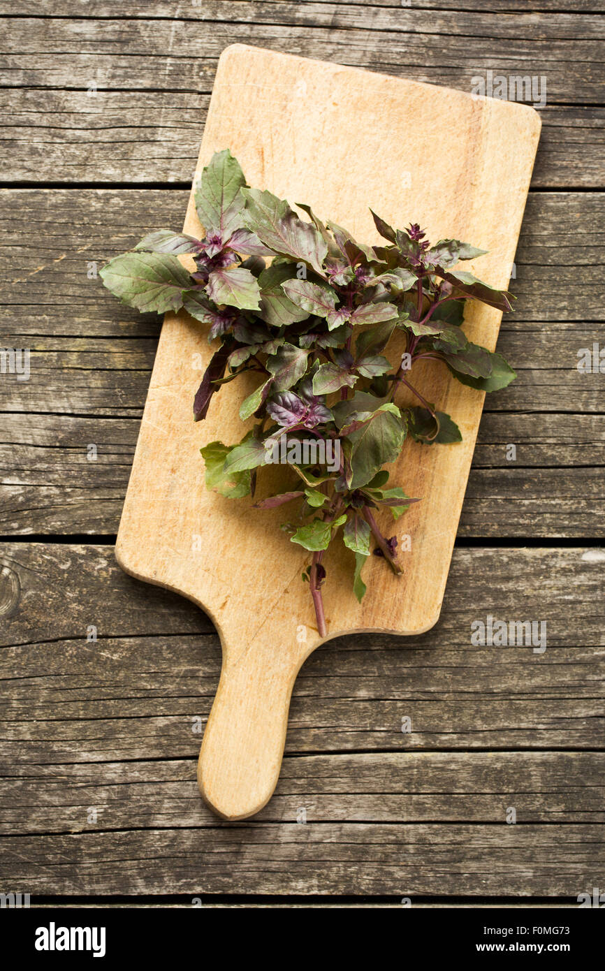 bunch of basil on old wooden table Stock Photo - Alamy