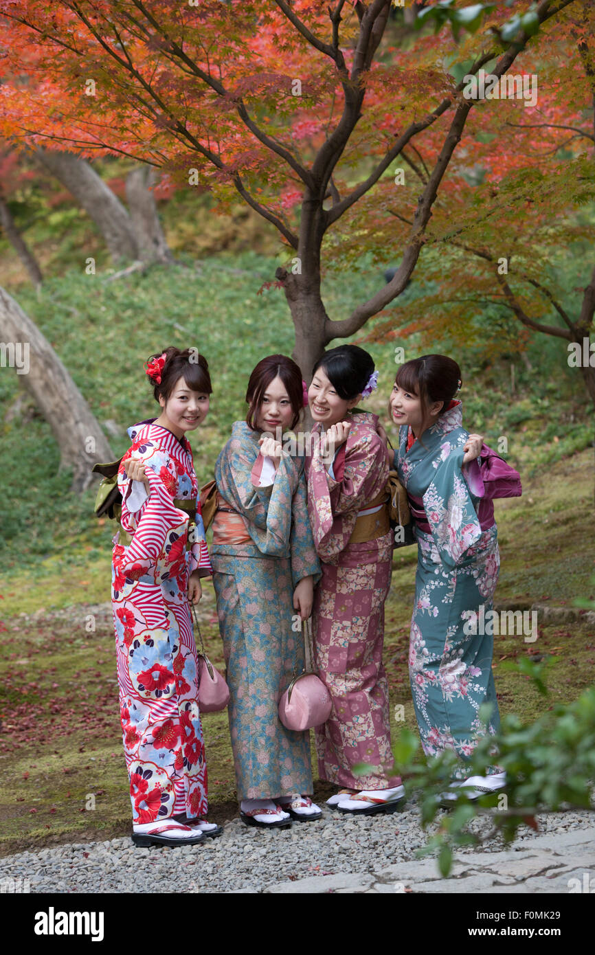 Young Japanese girls in kimonos posing under autumnal maple tree, Kodai-ji, Southern Higashiyama, Kyoto, Japan, Asia Stock Photo