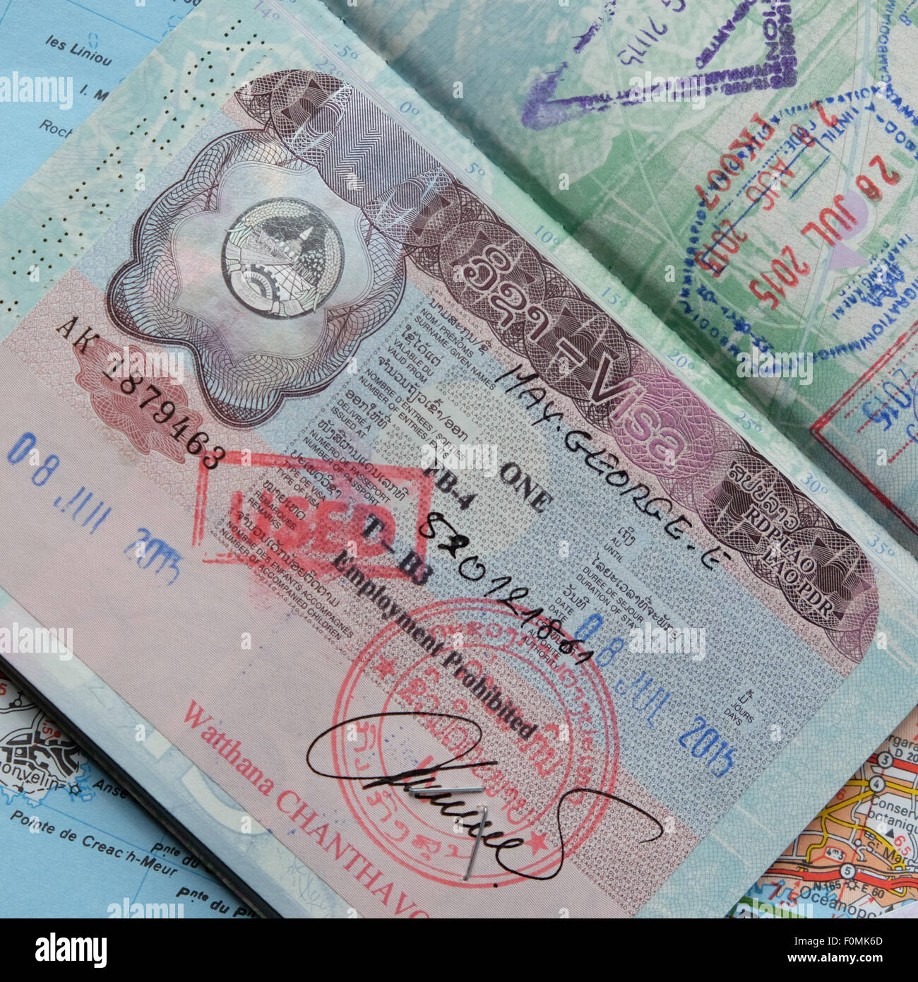 Passport travel visa for Lao Laos stamped inside a UK passport Stock Photo  - Alamy