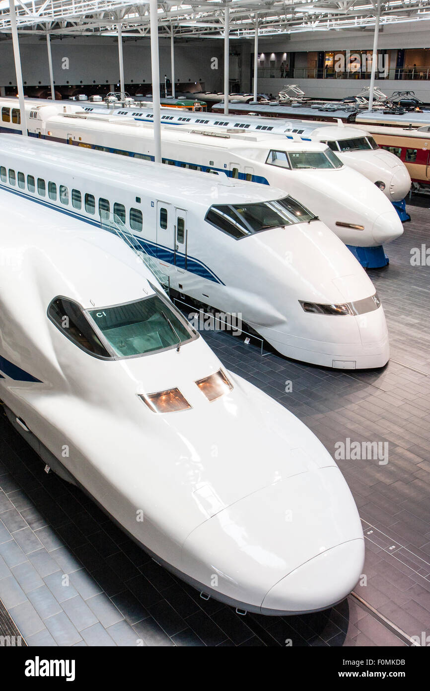 Japan, Nagoya, Railway park. Interior of the Shinkansen Museum. Four bullet trains, 700 series nearest, then 200, 100 and 0 arranged in a line. Stock Photo