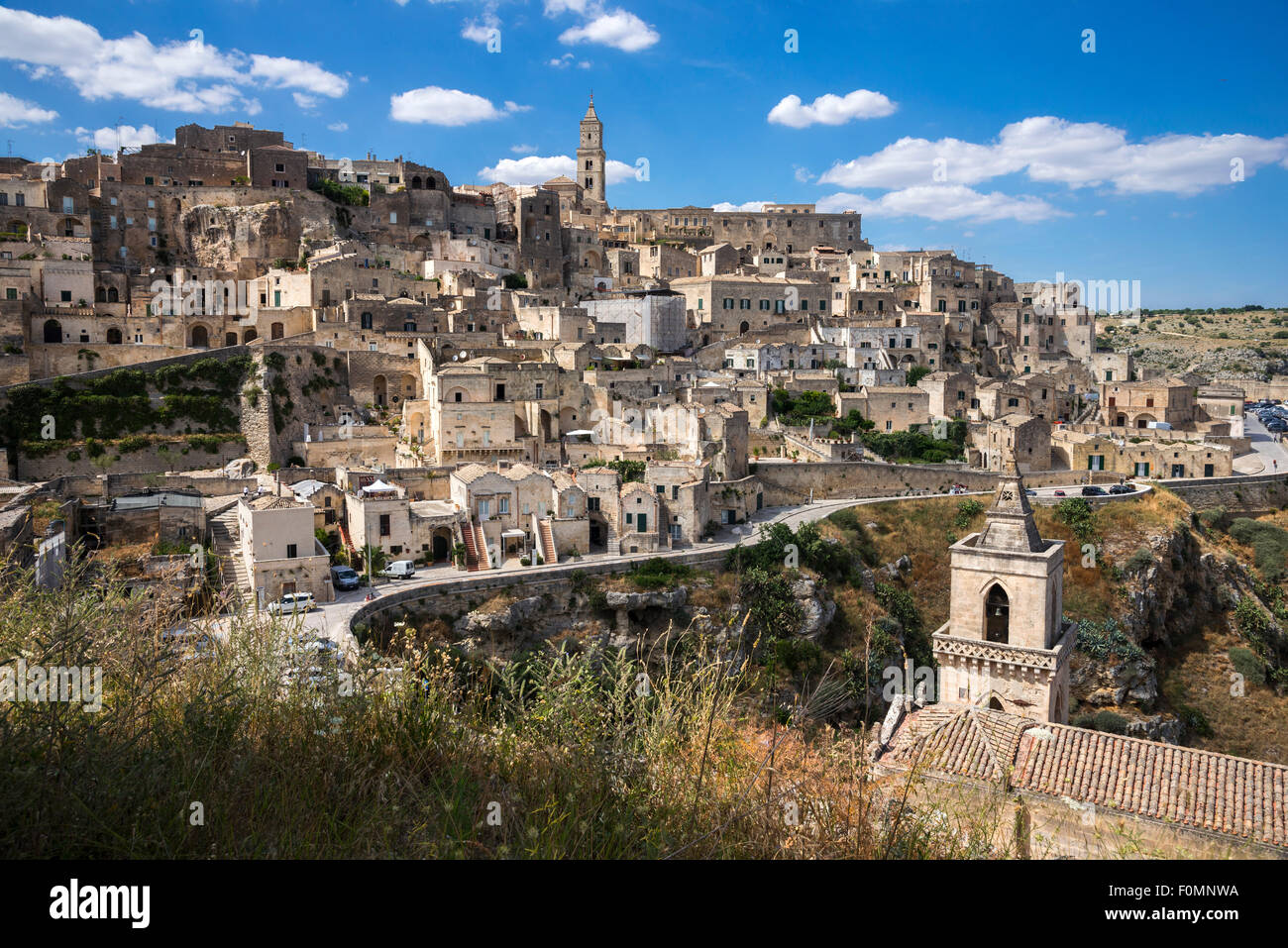 Looking over the town of Matera to the Duomo with San Pietro Caveoso in the forground, Basilicata, Southern Italy Stock Photo