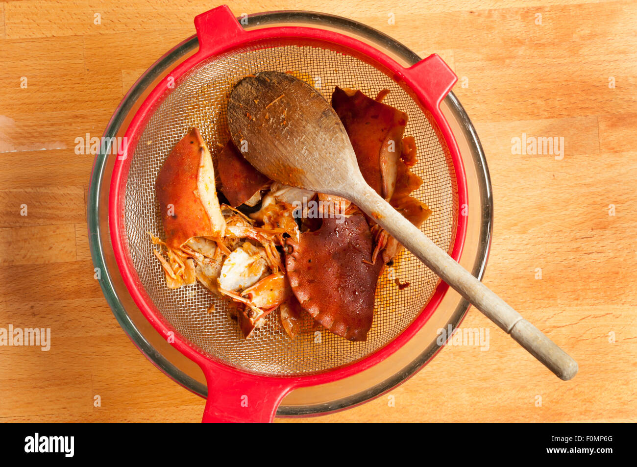 Making a fish stock by boiling broken crab and prawn shells and