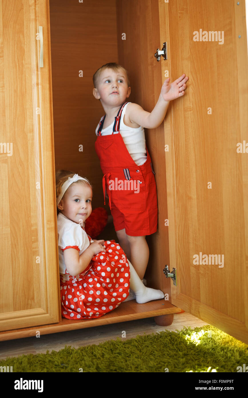 boy with girl playing hide and seek Stock Photo