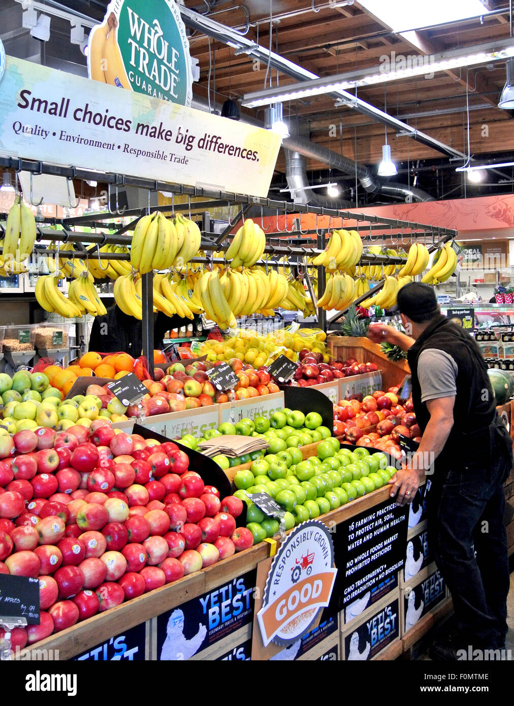 whole food employee stocks produce shelfs at Mill Valley natural food store Stock Photo