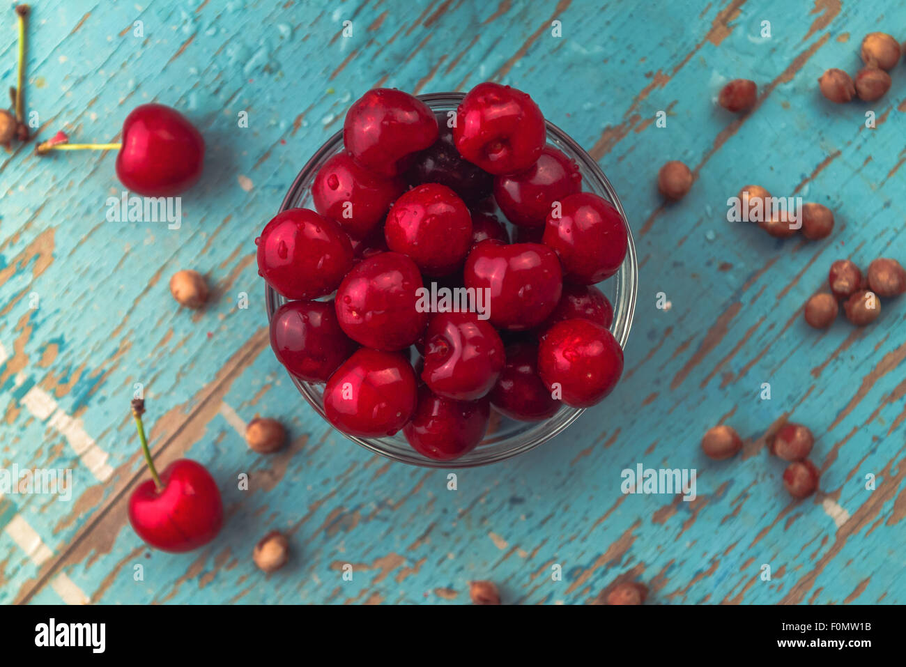 Sweet Cherry in Bowl on Rustic Table, Ripe Fresh Wild Cherries Fruit, Top View Stock Photo