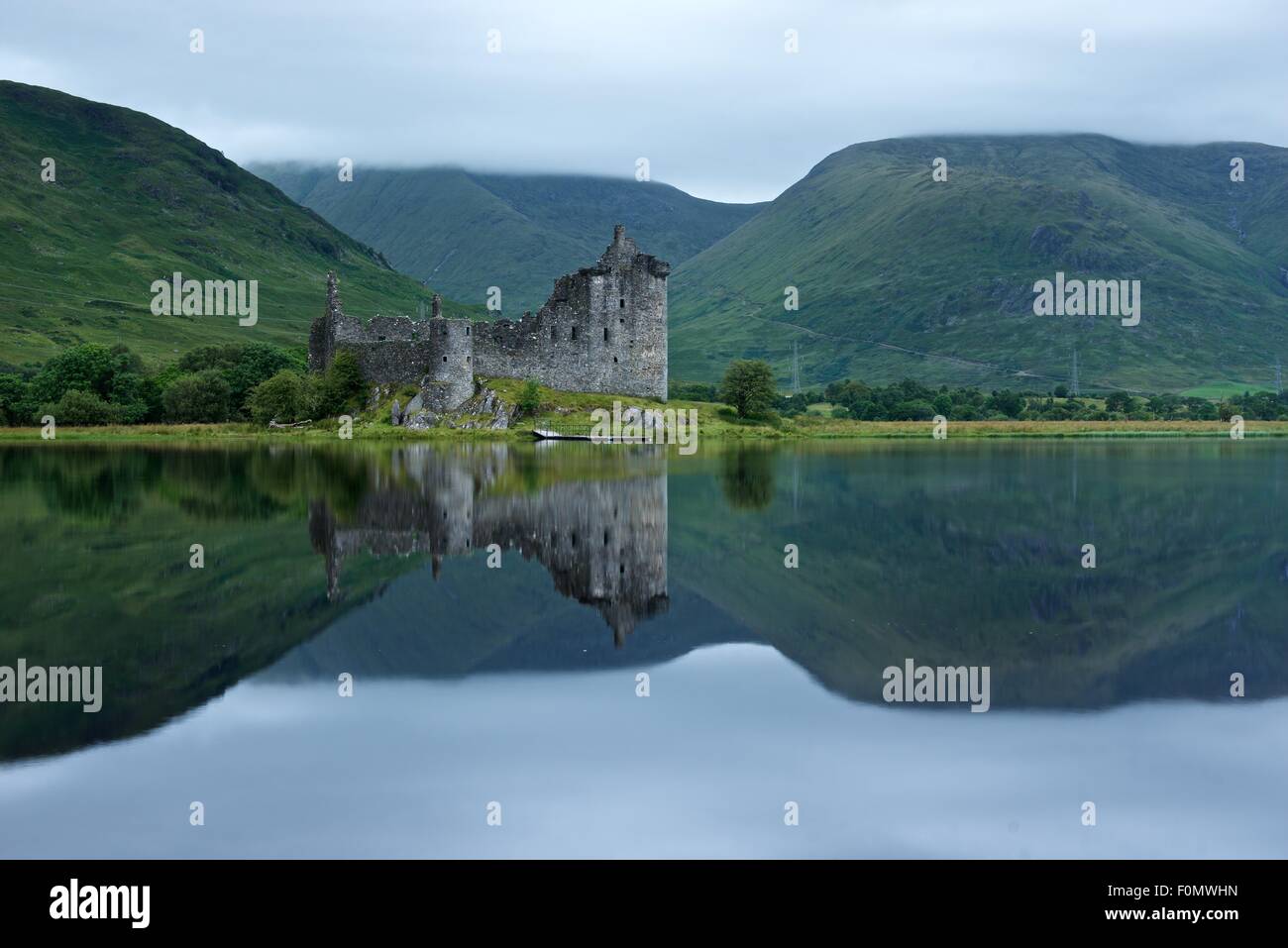 A colour image of the morning reflections in Loch Awe of Kilchurn castle in Argyll Stock Photo