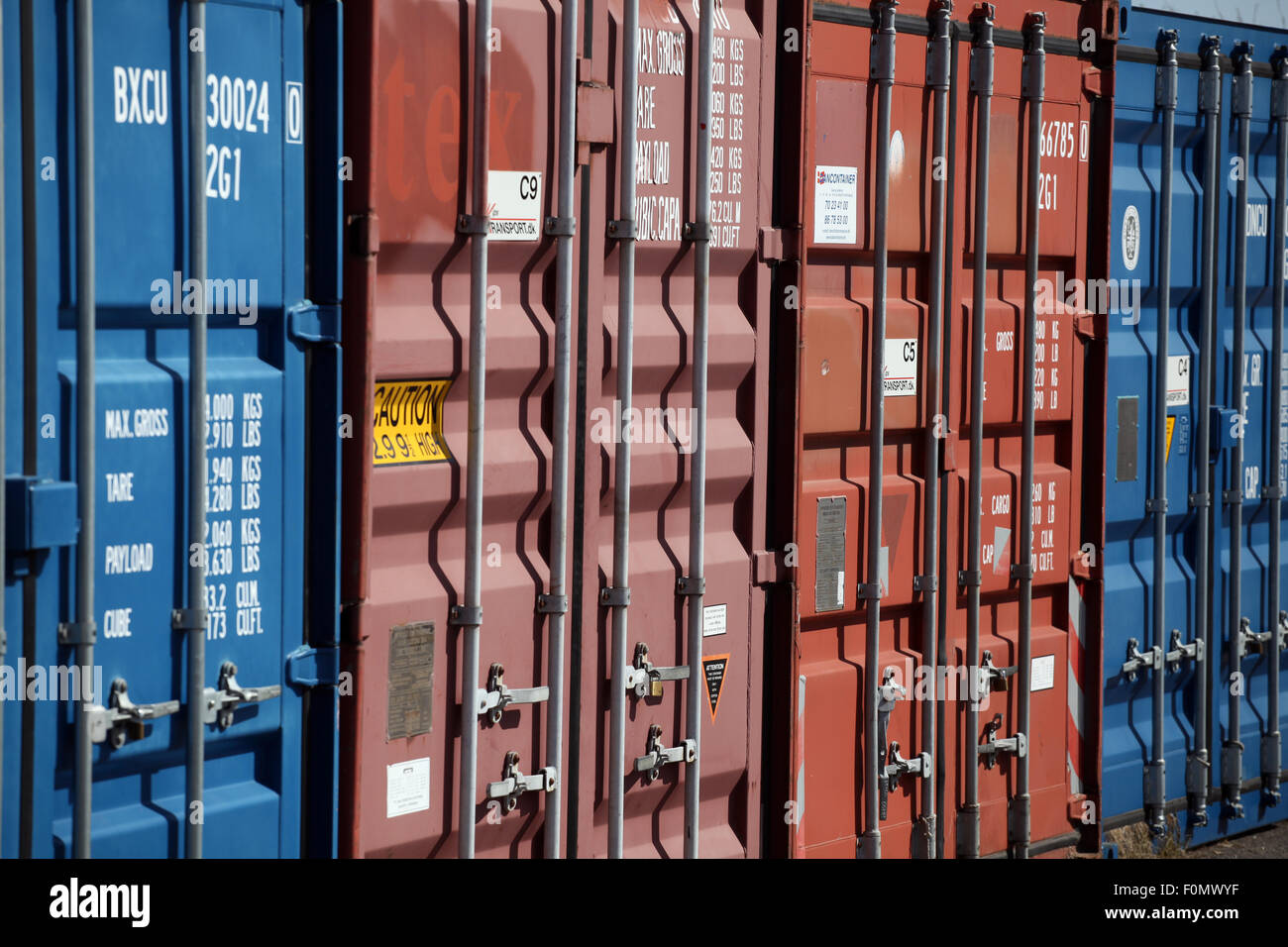Blue and red cargo containers locked Stock Photo Alamy