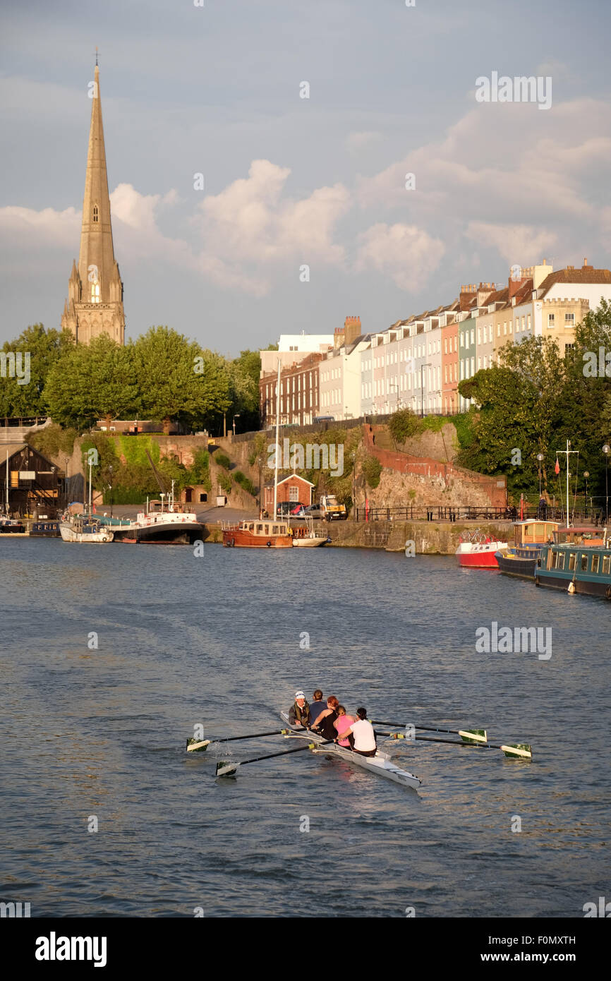 A view towards Redcliffe as people row on the floating harbour in Bristol in evening sunlight Stock Photo