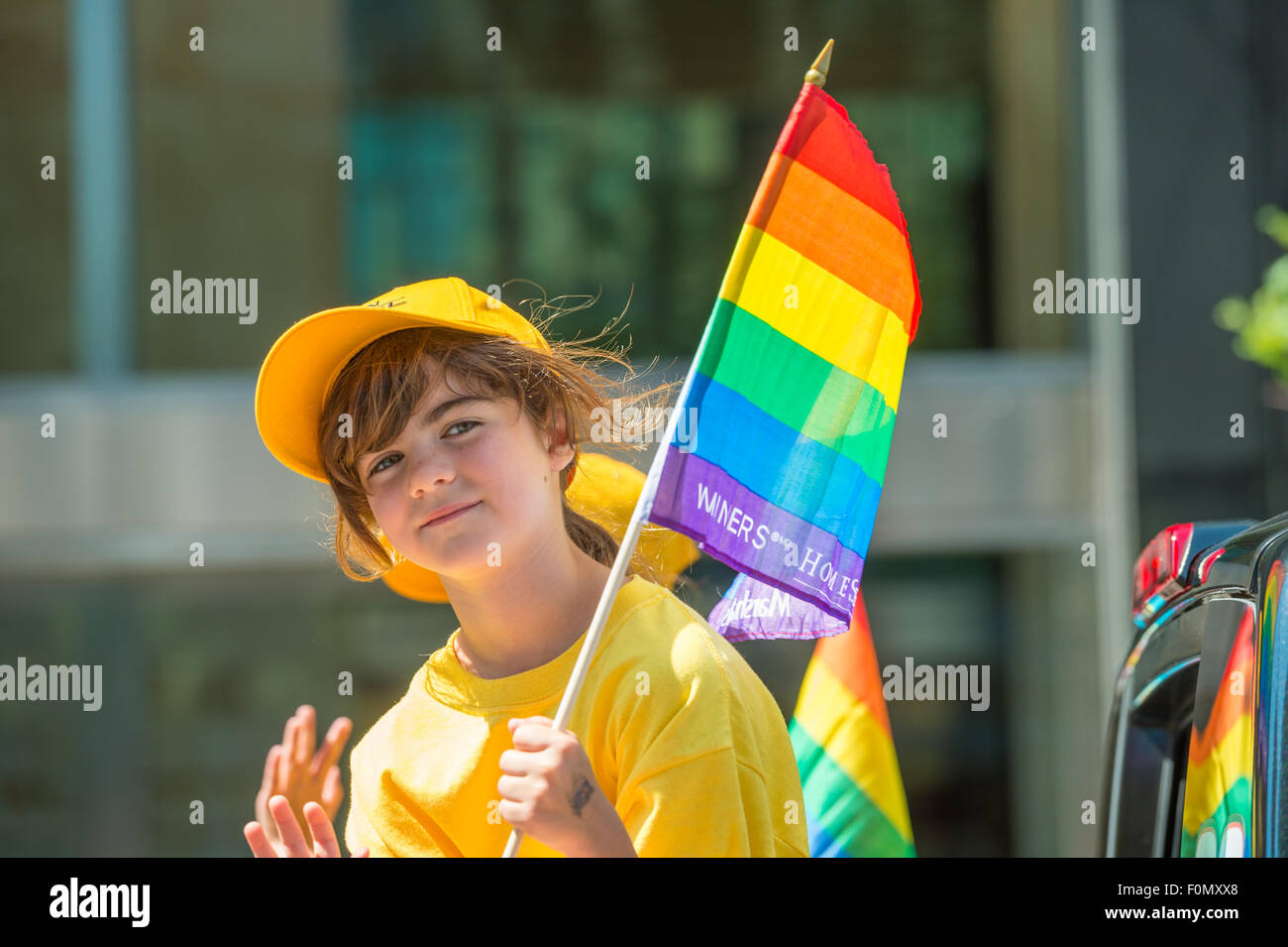 MONTREAL, CANADA, 16th August 2015. A young girl on a parade truck is smiling at the camera at the 2015 Gay Pride Parade in Montreal. © Marc Bruxelle/Alamy Live News Stock Photo
