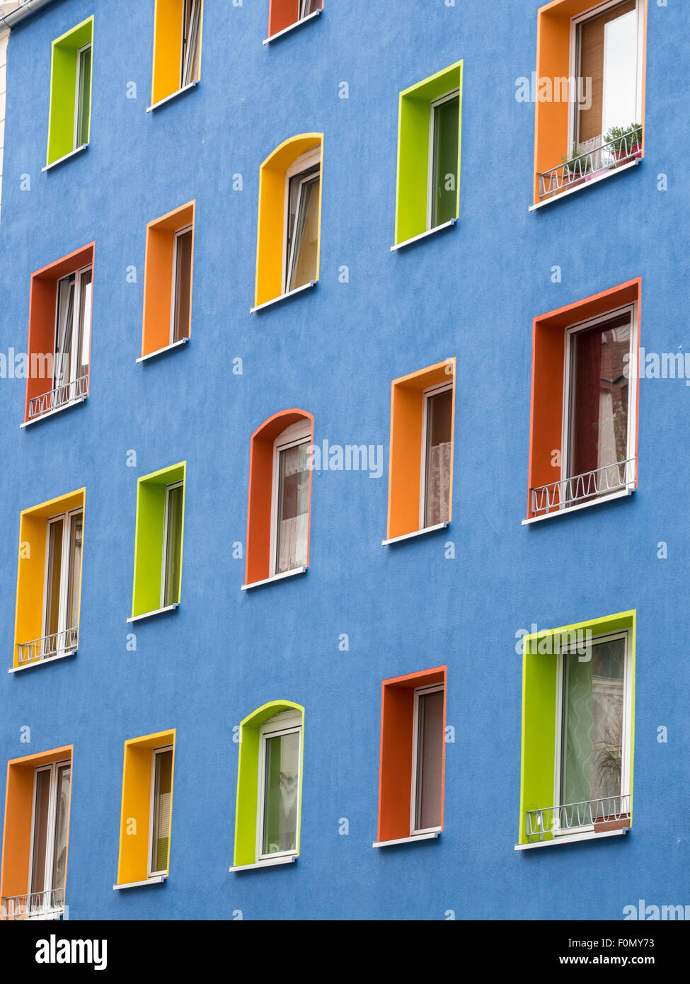 Exterior wall, blue colored building, multi-colored windows, Hannover-Linden, Hannover, Germany Stock Photo