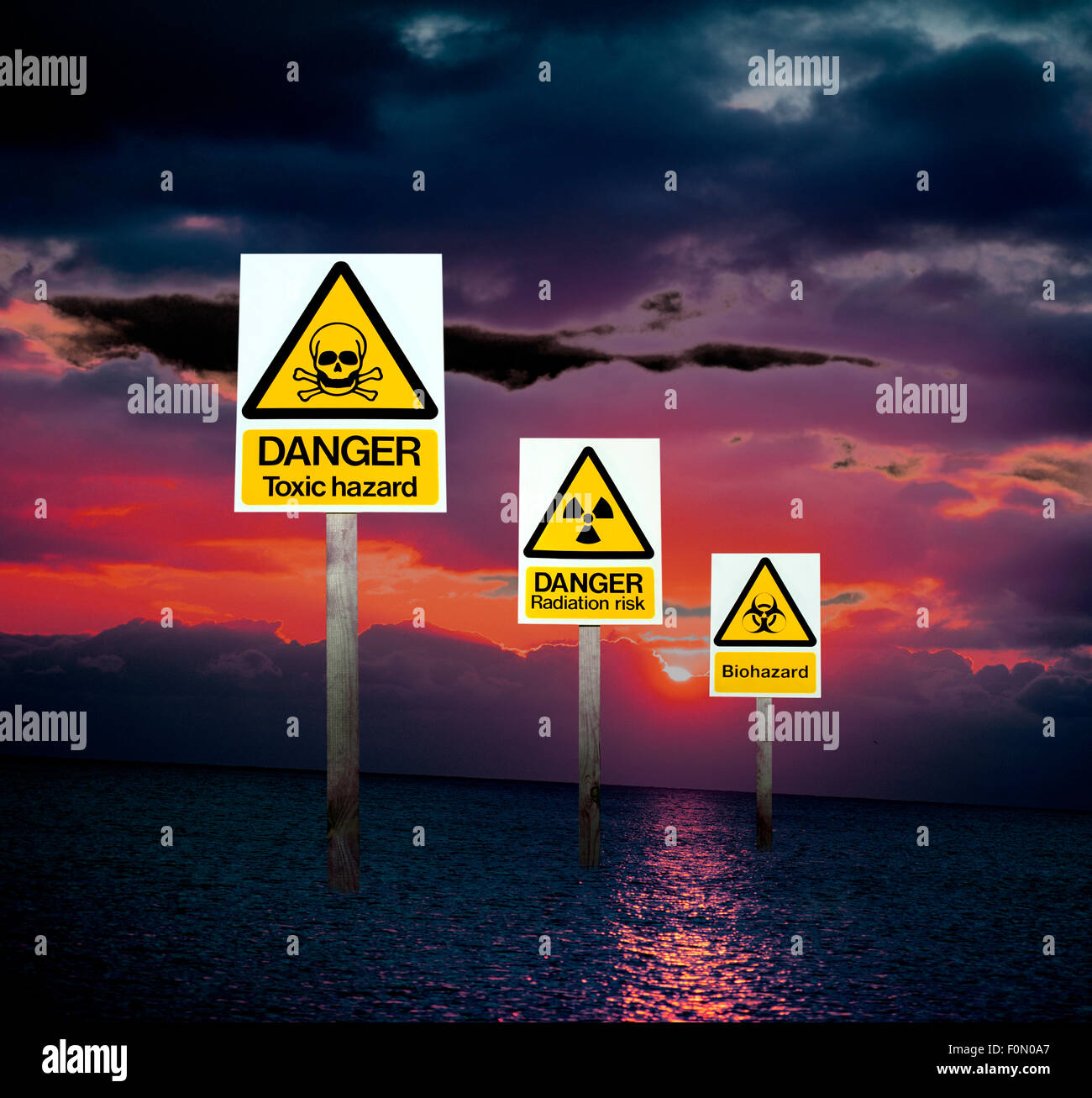 Three warning signs of health hazards and environmental dangers in a digital image illustrating a world of polluted air and sea. Stock Photo