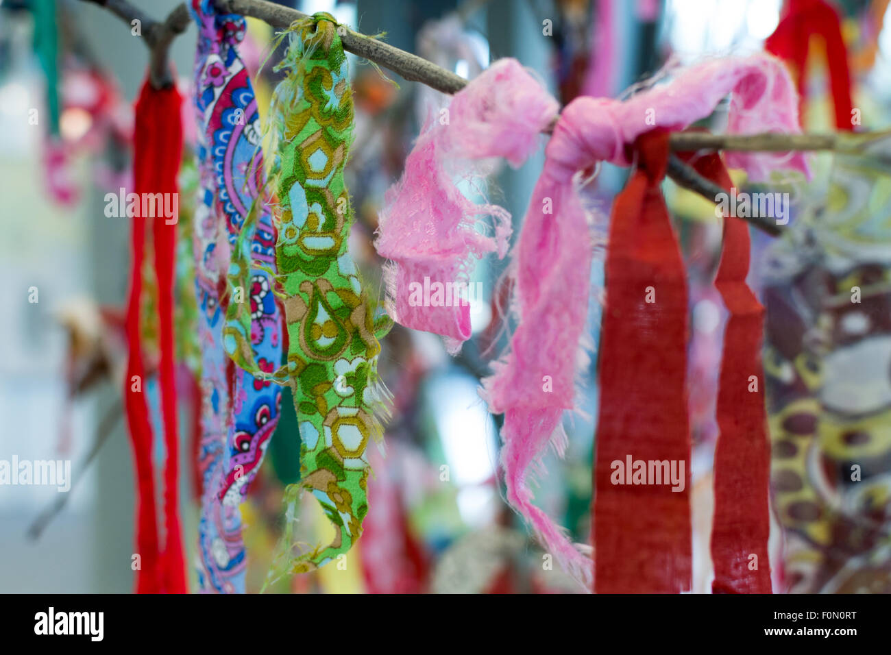 Bright cloth rags tied to a tree branch Stock Photo