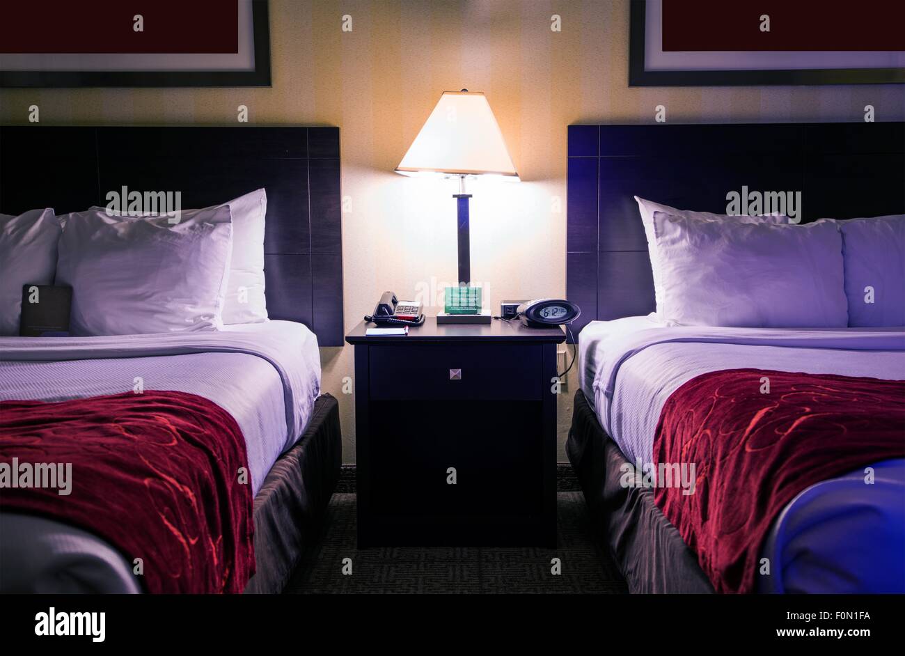 Hotel Room Interior at Night. Two Queen Size Beds in Hotel Room Stock