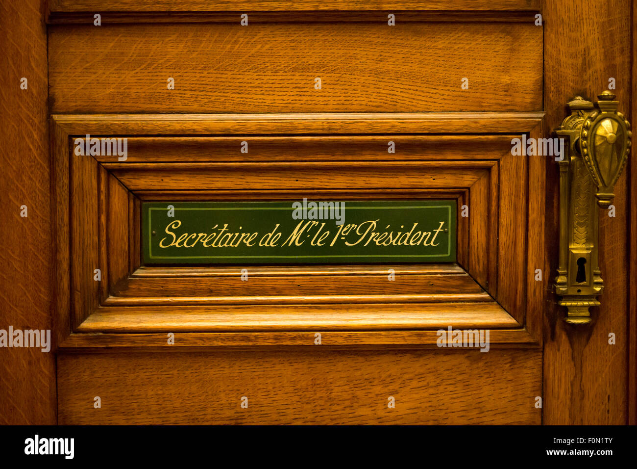Classical style wooden door with sign saying: Secretary of the president written in French. Courthouse in Brussels. Belgium. Stock Photo