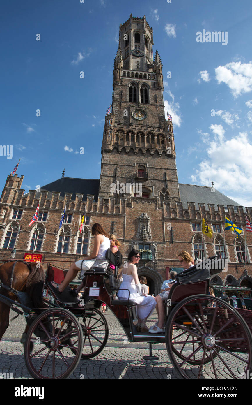 Unidentified People on a traditional horse carriage on the square of the city hall in Bruges, Belgium 2012. Stock Photo