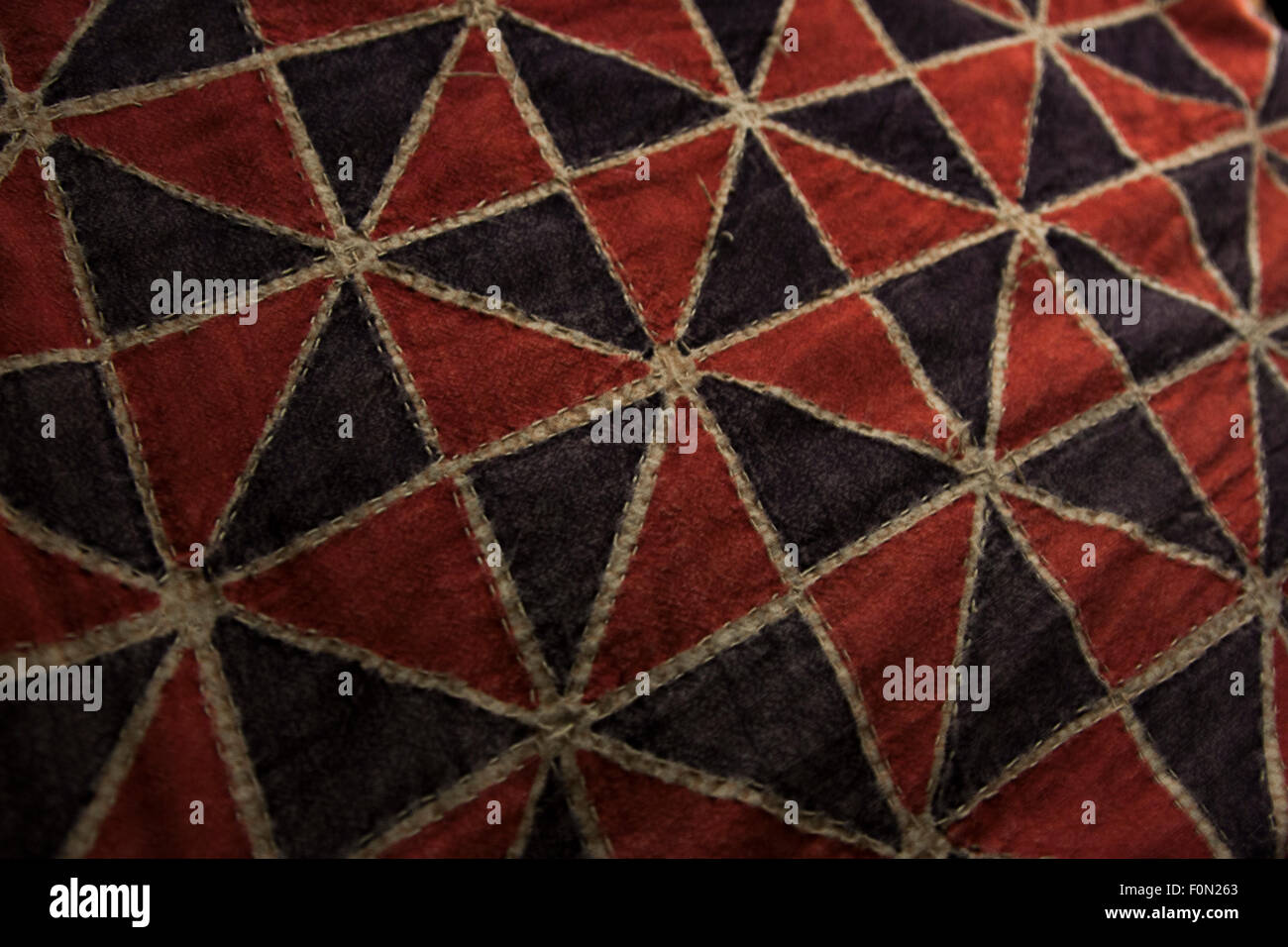 Pinwheel pattern in red and black on an Indian bedspread. Stock Photo