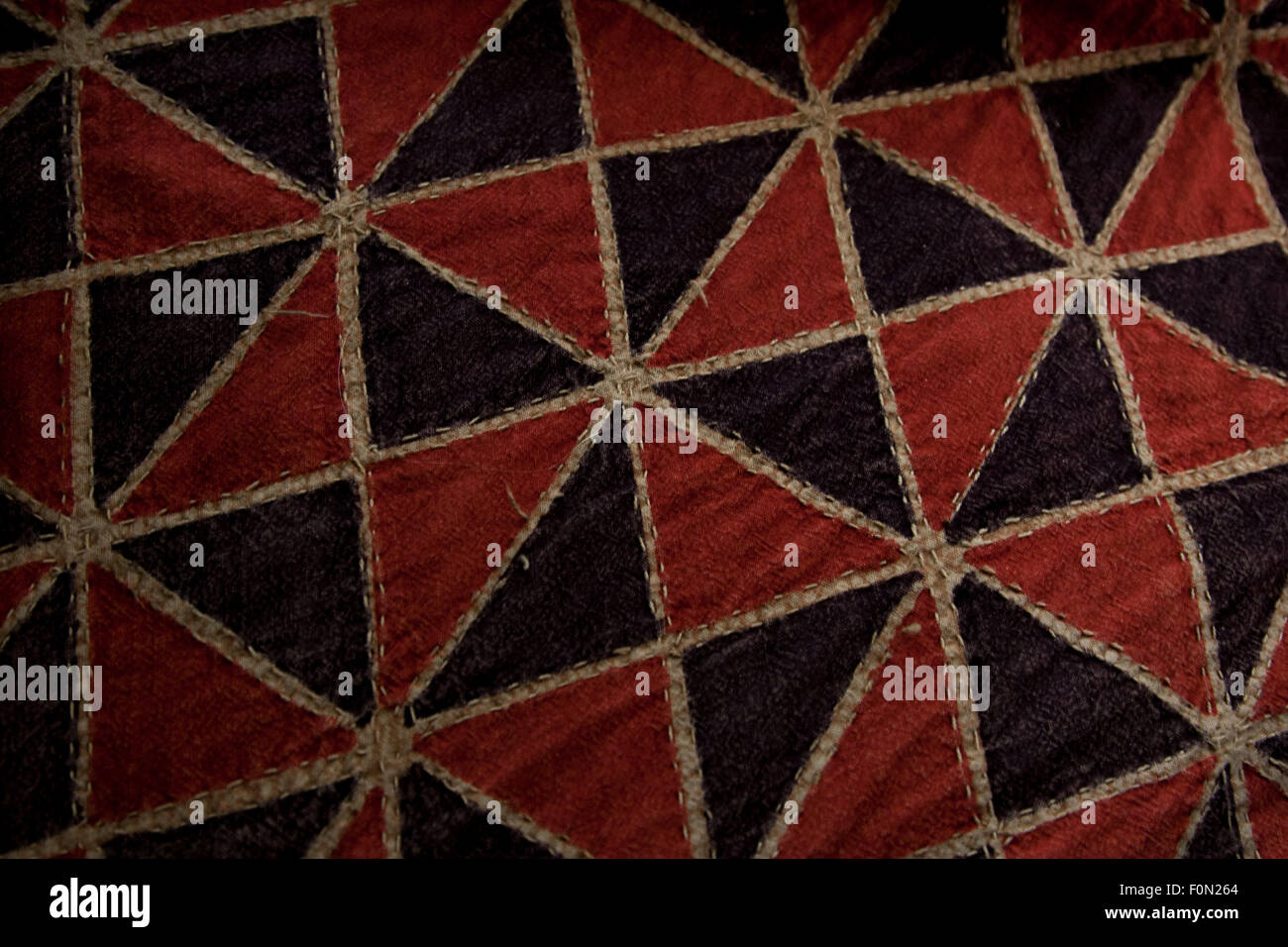Pinwheel pattern in red and black on an Indian bedspread. Stock Photo