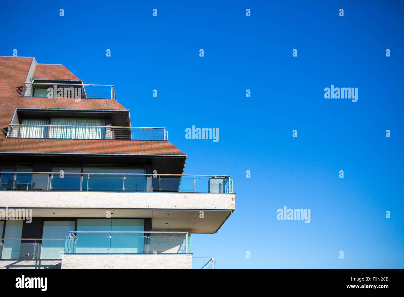 New apartments building and blue sky as a background Stock Photo Alamy