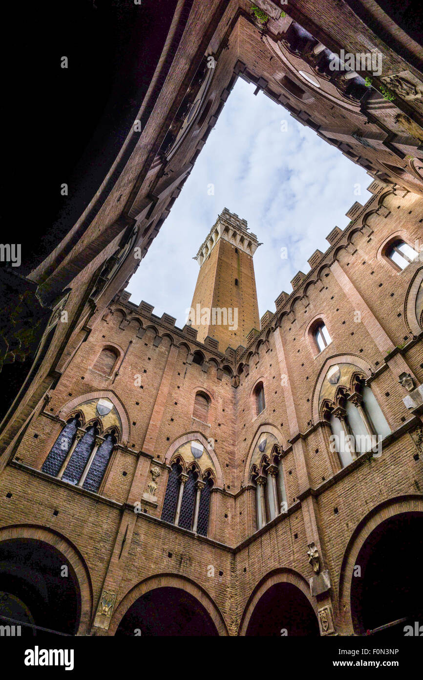 Torre del Mangia tower, as seen from the courtyard of the Podesta, Piazza del Campo, Siena, Italy. Stock Photo