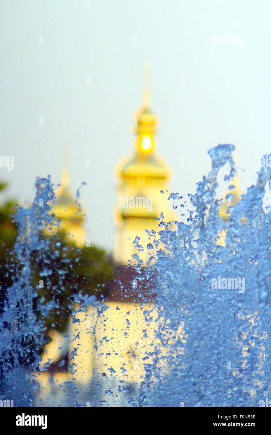 fountains on the background of beautiful golden church domes Stock Photo