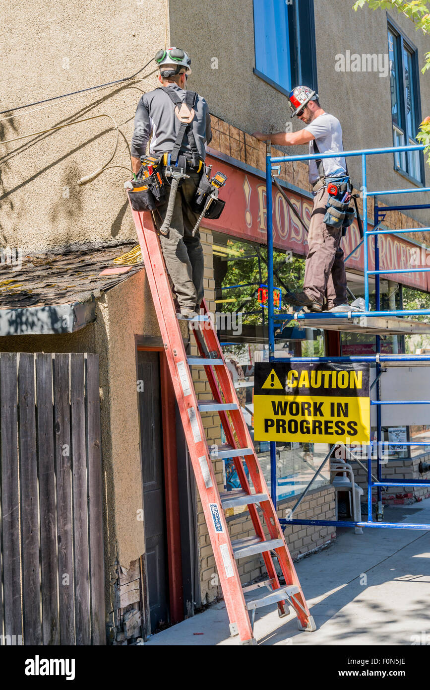 Men at work on scaffold and ladder, Rossland, British Columbia, Canada