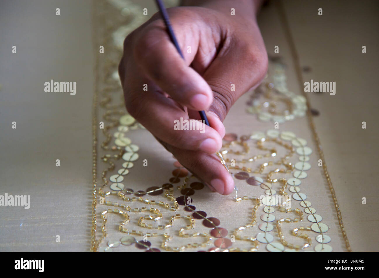 Close up on the hand-embroidery in a fair-trade workshop in Agra, India. Stock Photo