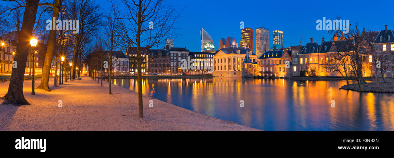 The Dutch Parliament buildings at the Binnenhof from across the Hofvijver pond in The Hague, The Netherlands at night. Stock Photo