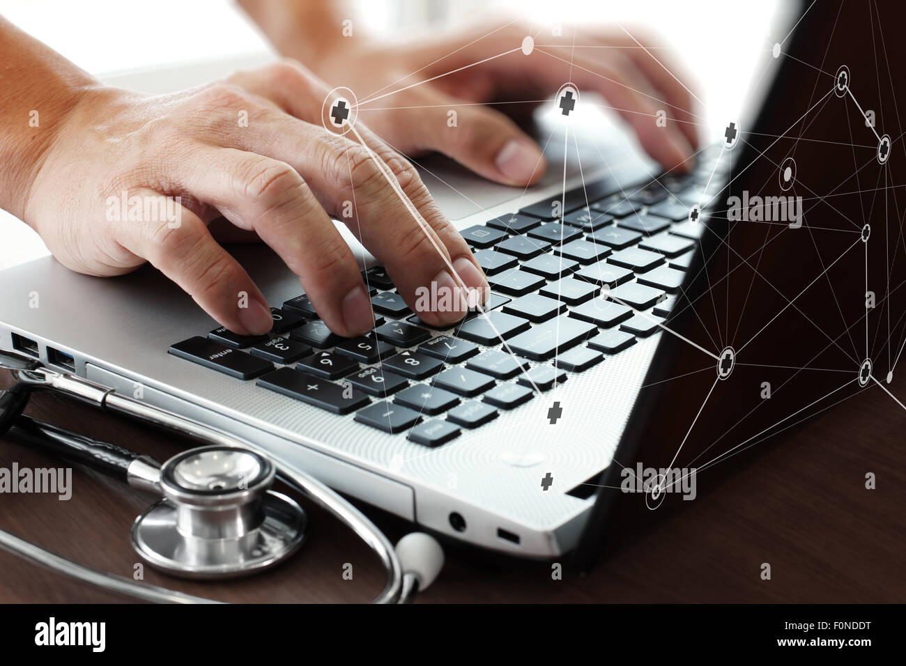 Health In Hands Computer Doctor hand working with laptop computer in medical workspace office as ...