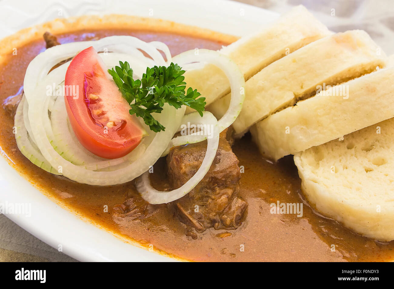 Goulash with onion and dumplings, typical Czech or German cuisine or dish. Stock Photo