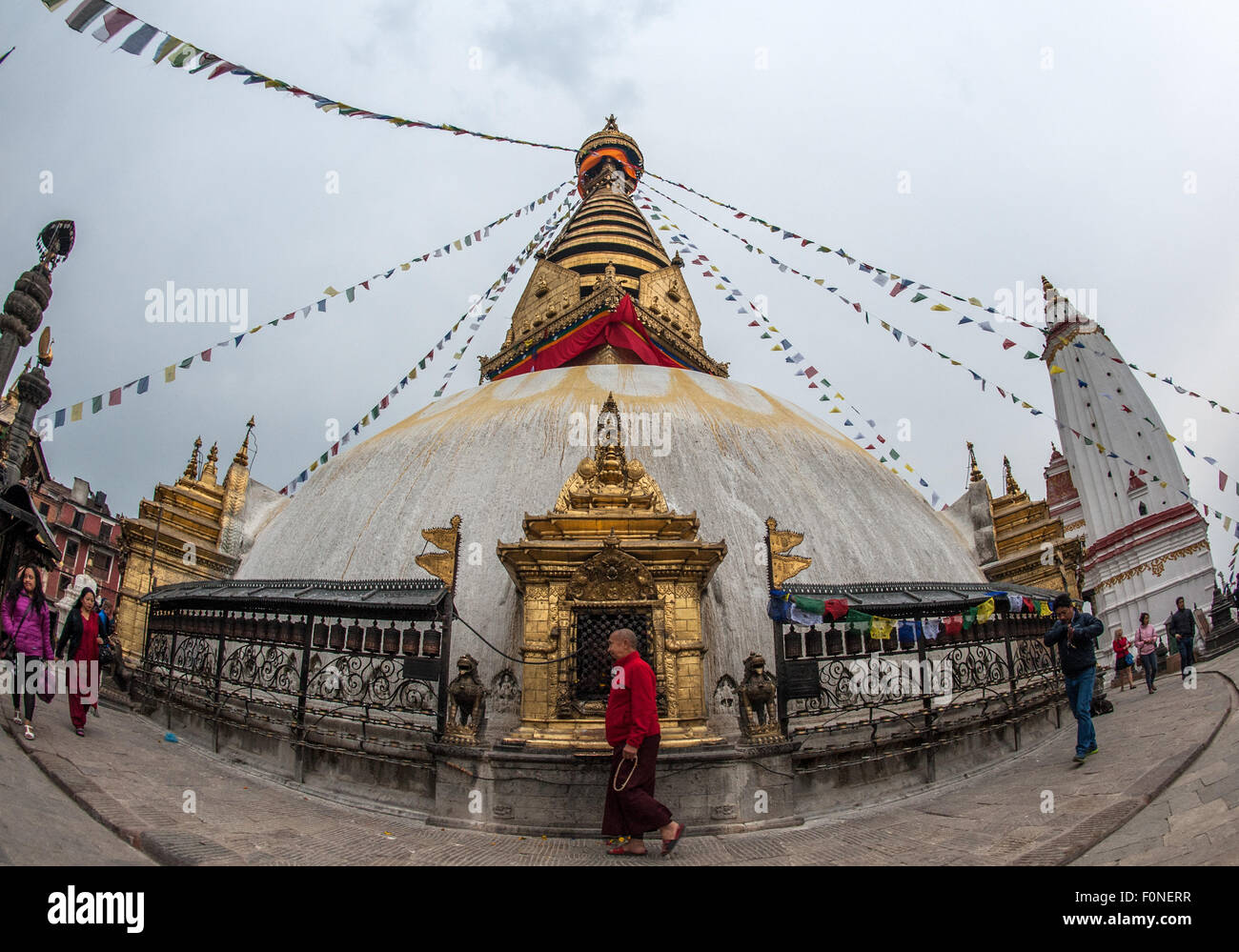Tibetan Buddhist monk walking at Swayambhunath or Monkey Temple Kathmandu Nepal Stock Photo
