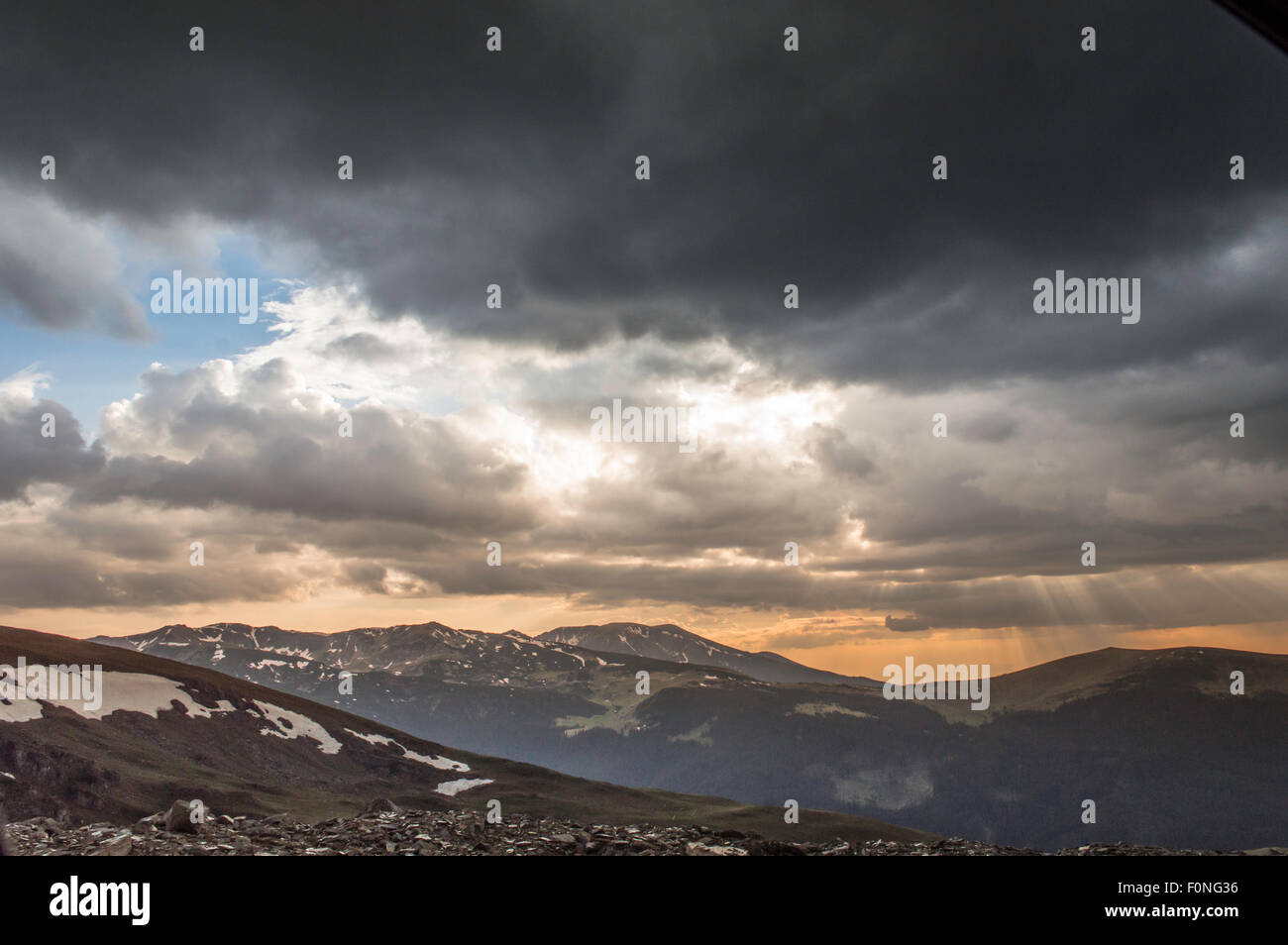 dramatic summer sunset with storm clouds in mountains Stock Photo - Alamy