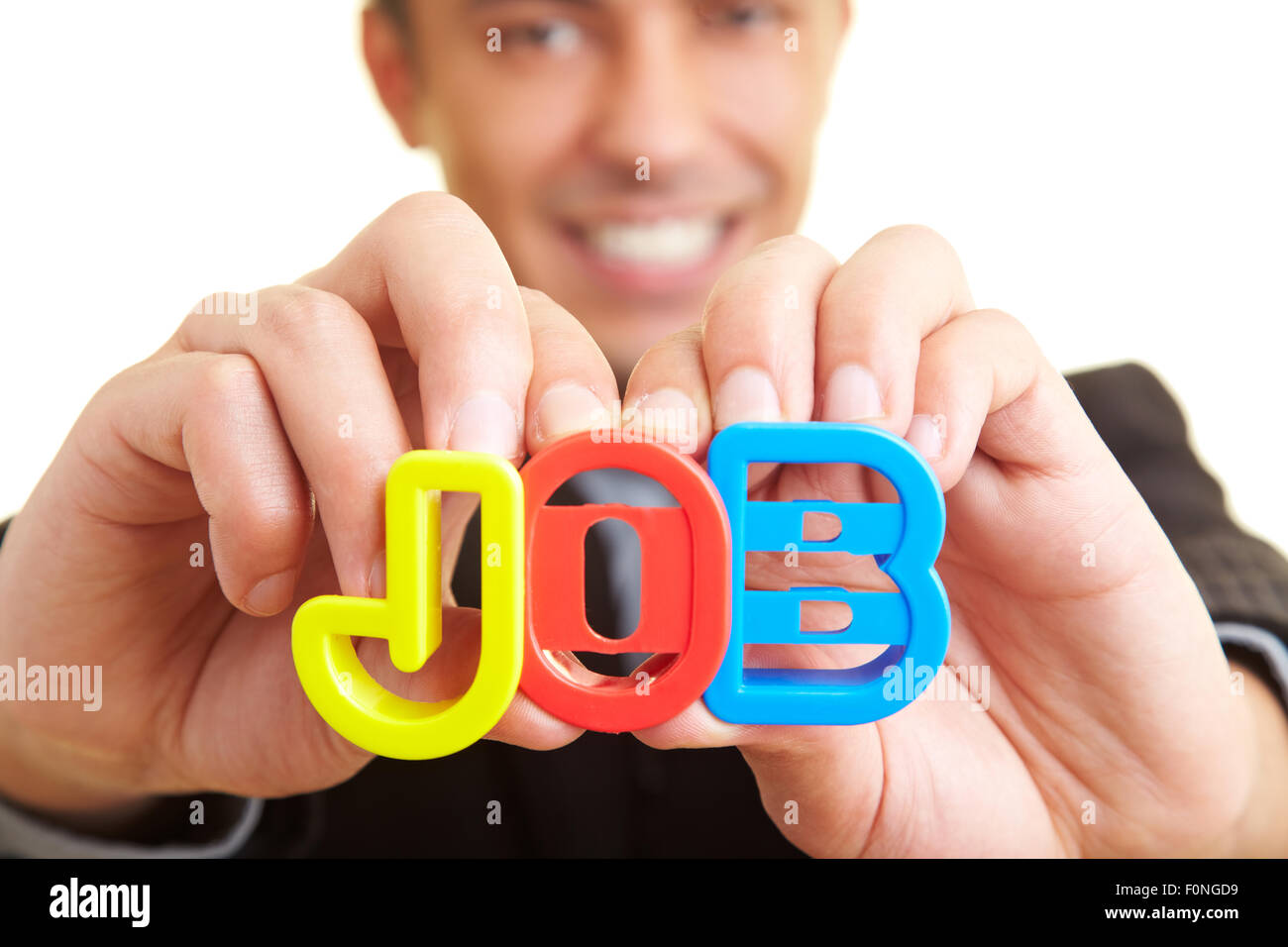 Businessman holding letters spelling 'JOB' Stock Photo