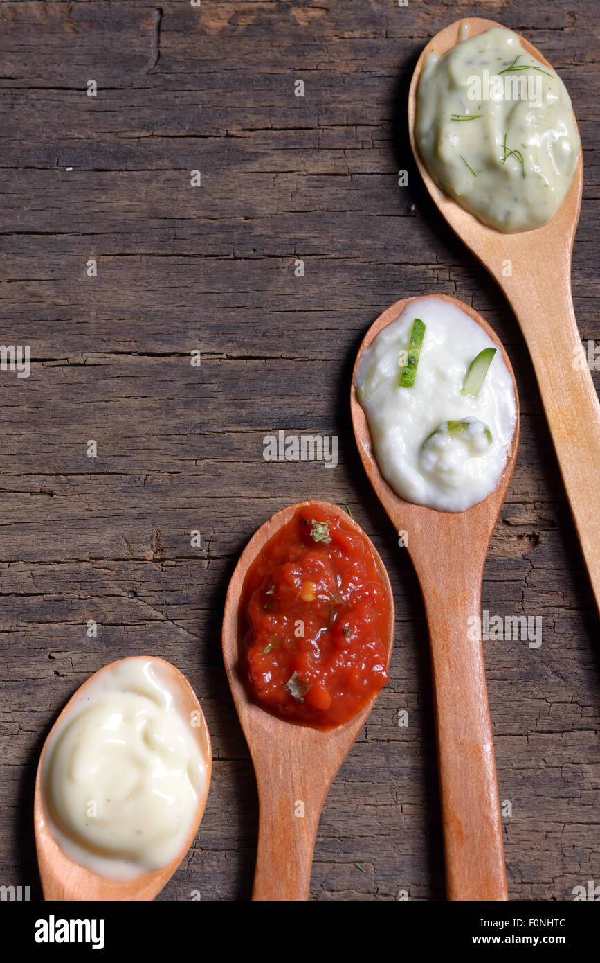 different types of sauces in spoons Stock Photo