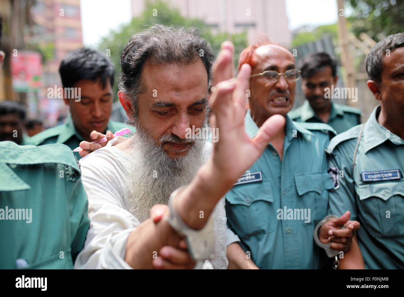 Dhaka, Bangladesh. 19th Aug, 2015.  Police bring British citizen Touhidur Rahman for his involvement in the murders of two secular bloggersto a Dhaka CMM court to plead for their remand in the case in Dhaka on August 19, 2015. CMM court remands three suspects in blogger for their involvement in the murders of two secular bloggers for 7 days.Bangladesh's elite security force arrested three suspected Islamist militants, including a British citizen whom police said was the ''main planner'' of the murder of two prominent atheist bloggers. Credit:  ZUMA Press, Inc./Alamy Live News Stock Photo