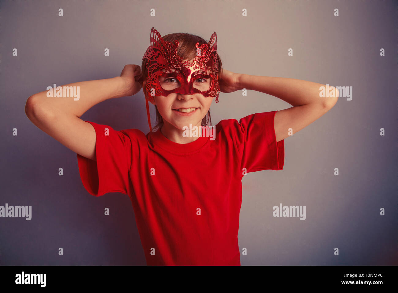 Boy teenager twelve years in the red shirt in the mask, super he Stock