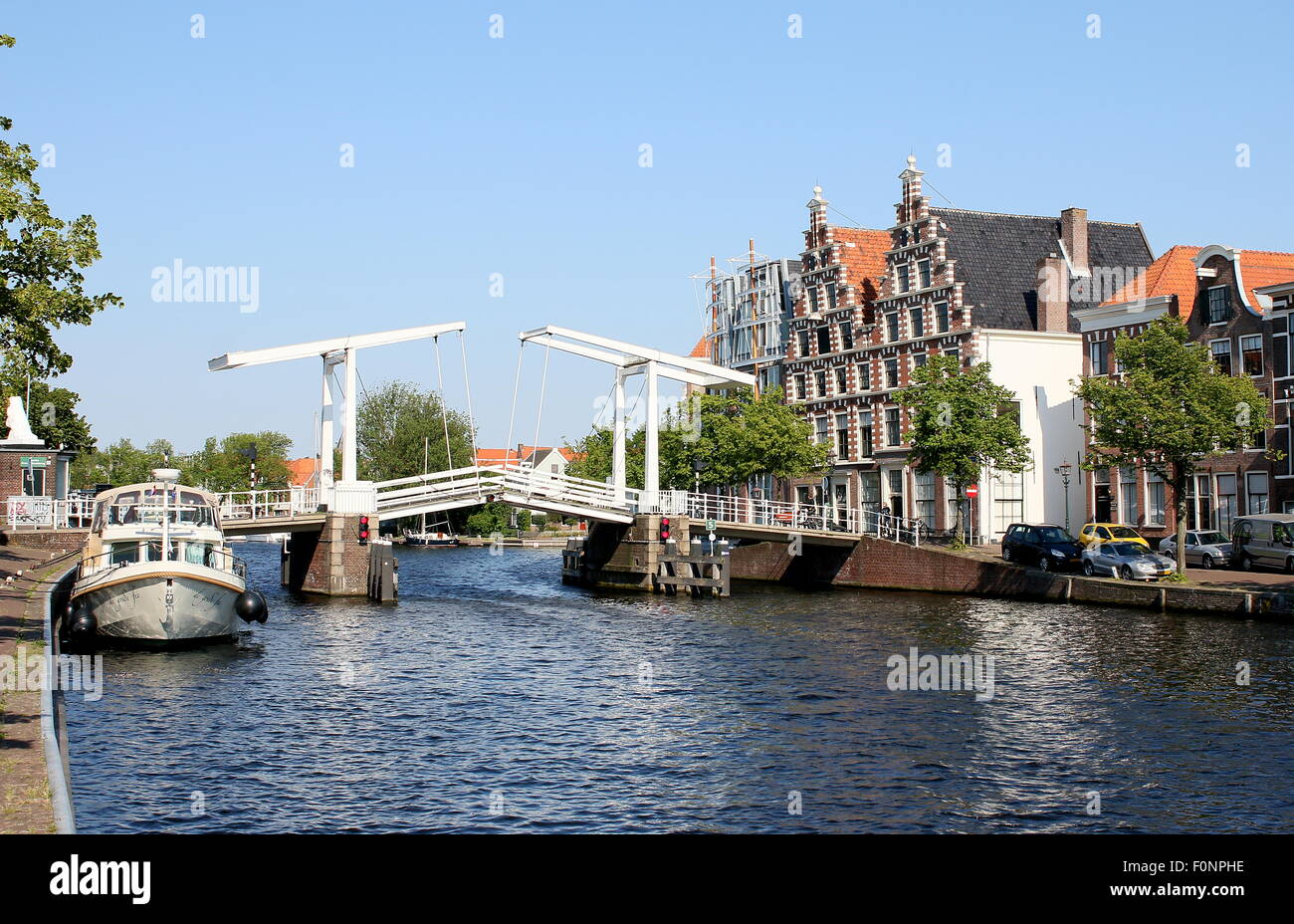 17th century Gravestenenbrug, an old wooden bridge over Spaane River in Haarlem, The Netherlands. On right De Olyphant warehouses Stock Photo