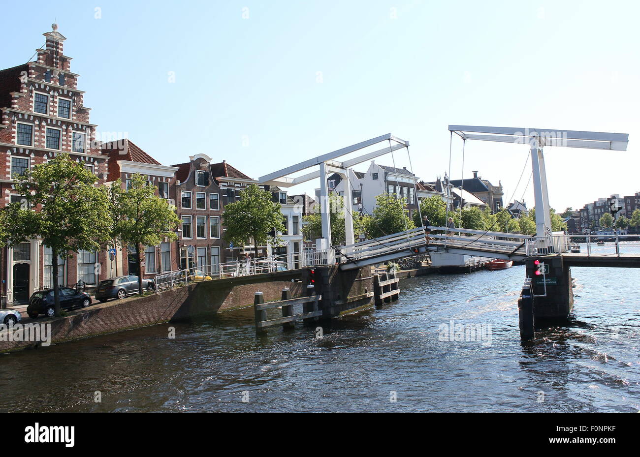 17th century Gravestenenbrug, an old wooden bridge over Spaane River in central Haarlem, Netherlands. On left 17th century warehouse De Olyphant Stock Photo
