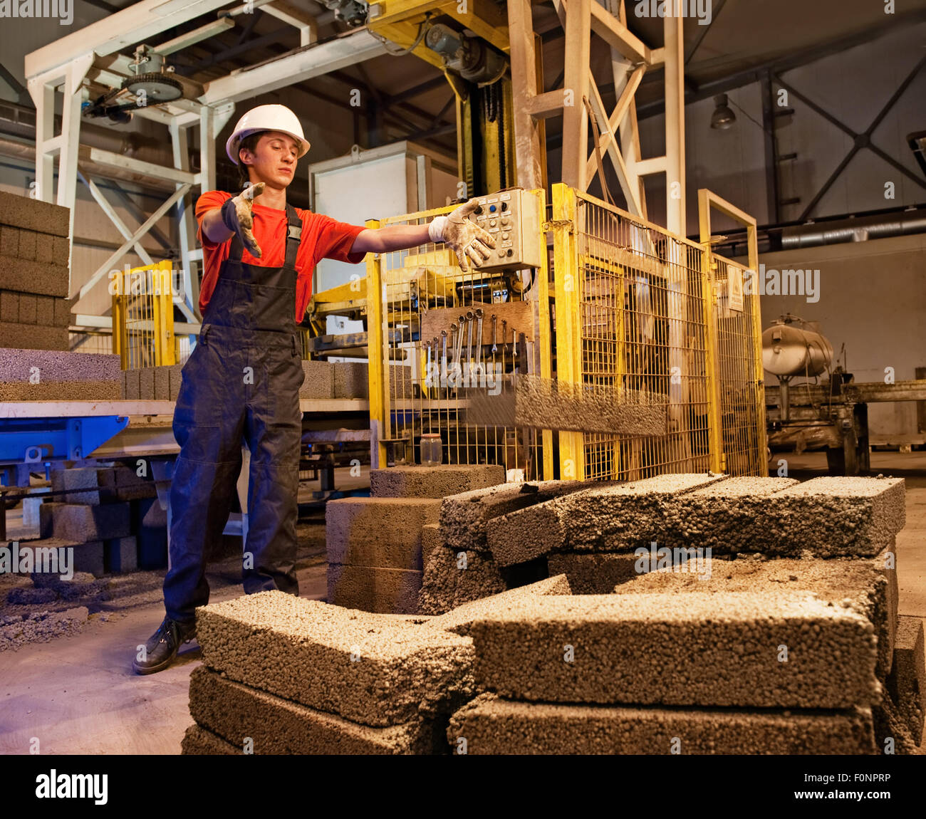 Factory worker throwing defective block Stock Photo Alamy