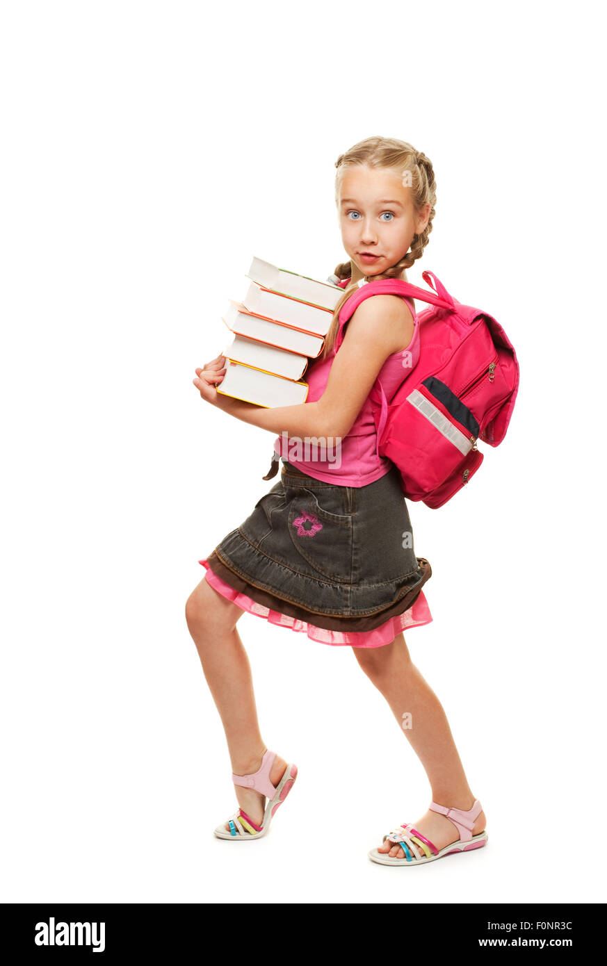 Happy little schoolgirl with a stack of heavy books Stock Photo - Alamy