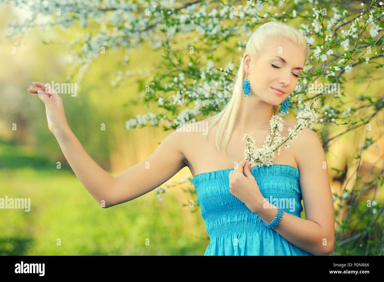 Beautiful young woman relaxing outdoors Stock Photo - Alamy
