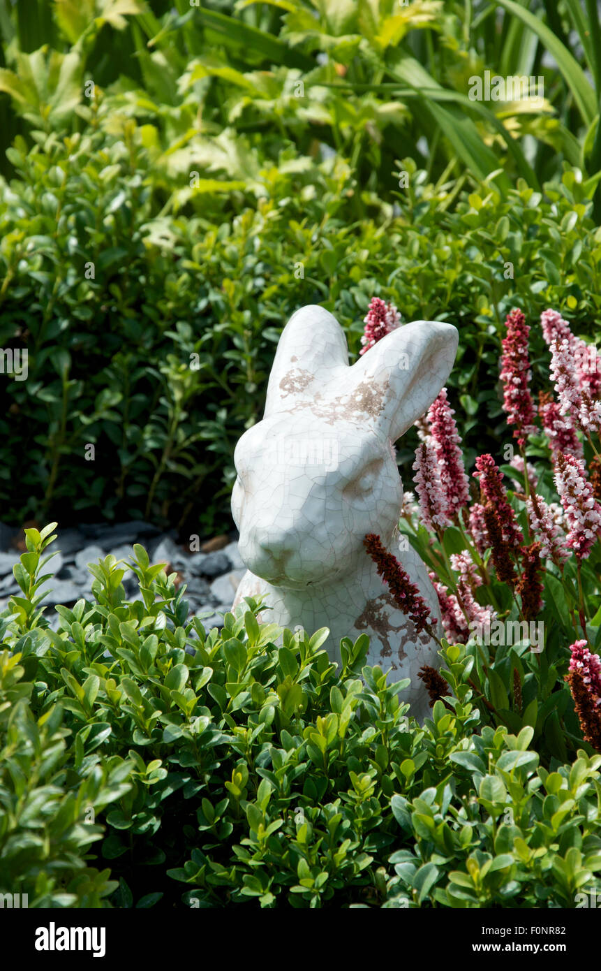 The White Rabbit figurine in the Mad Hatter's Tea Party themed garden at RHS Hampton Court Palace flower Show 2015 Stock Photo
