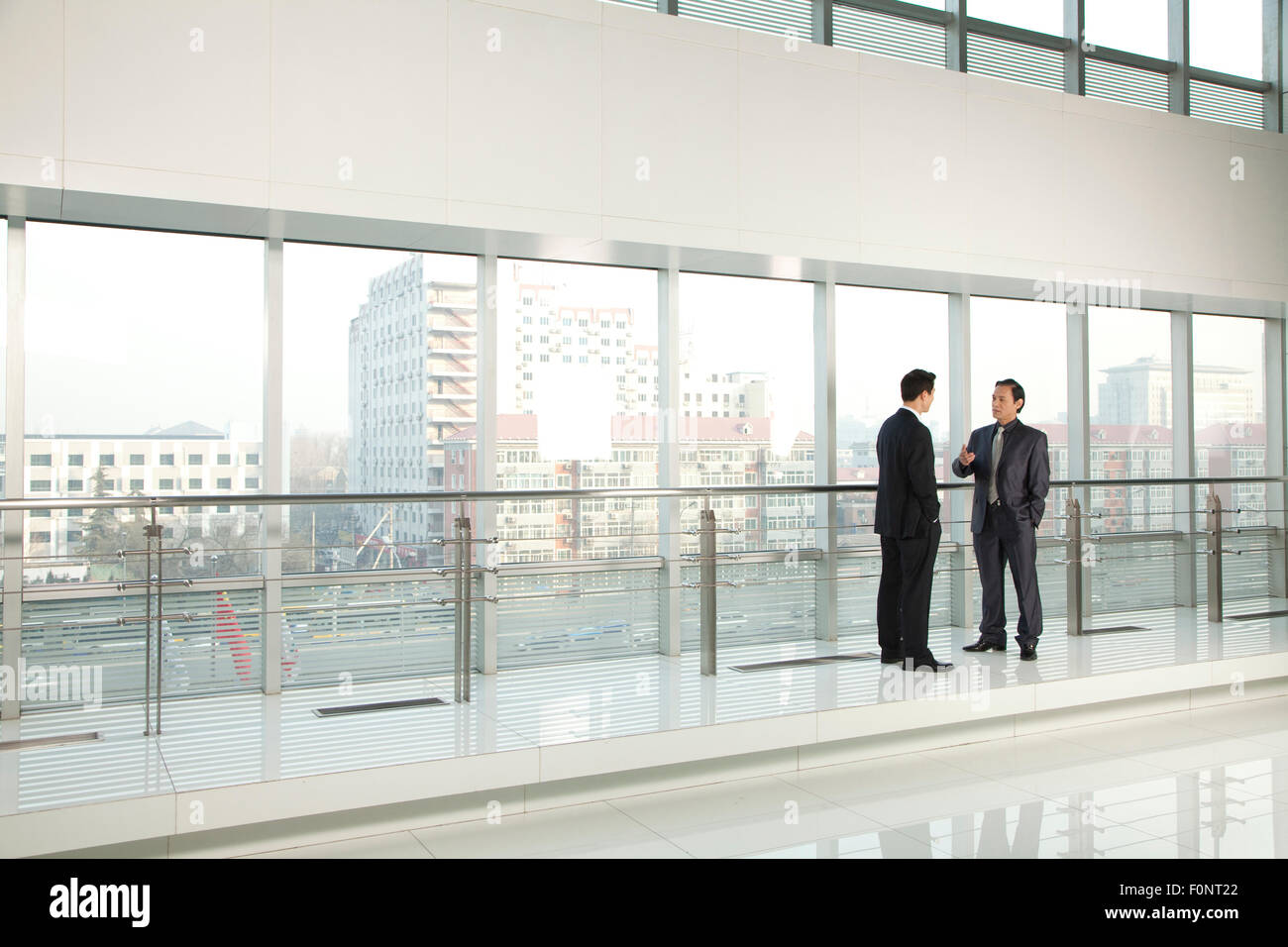 Two Businessmen Talking Stock Photo - Alamy