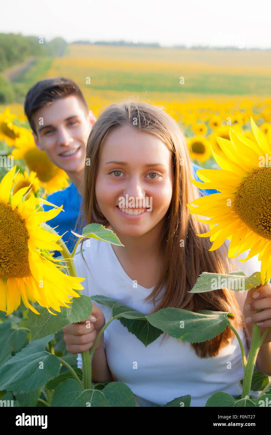 happy young couple in love have romance and fun at sunflower field in ...