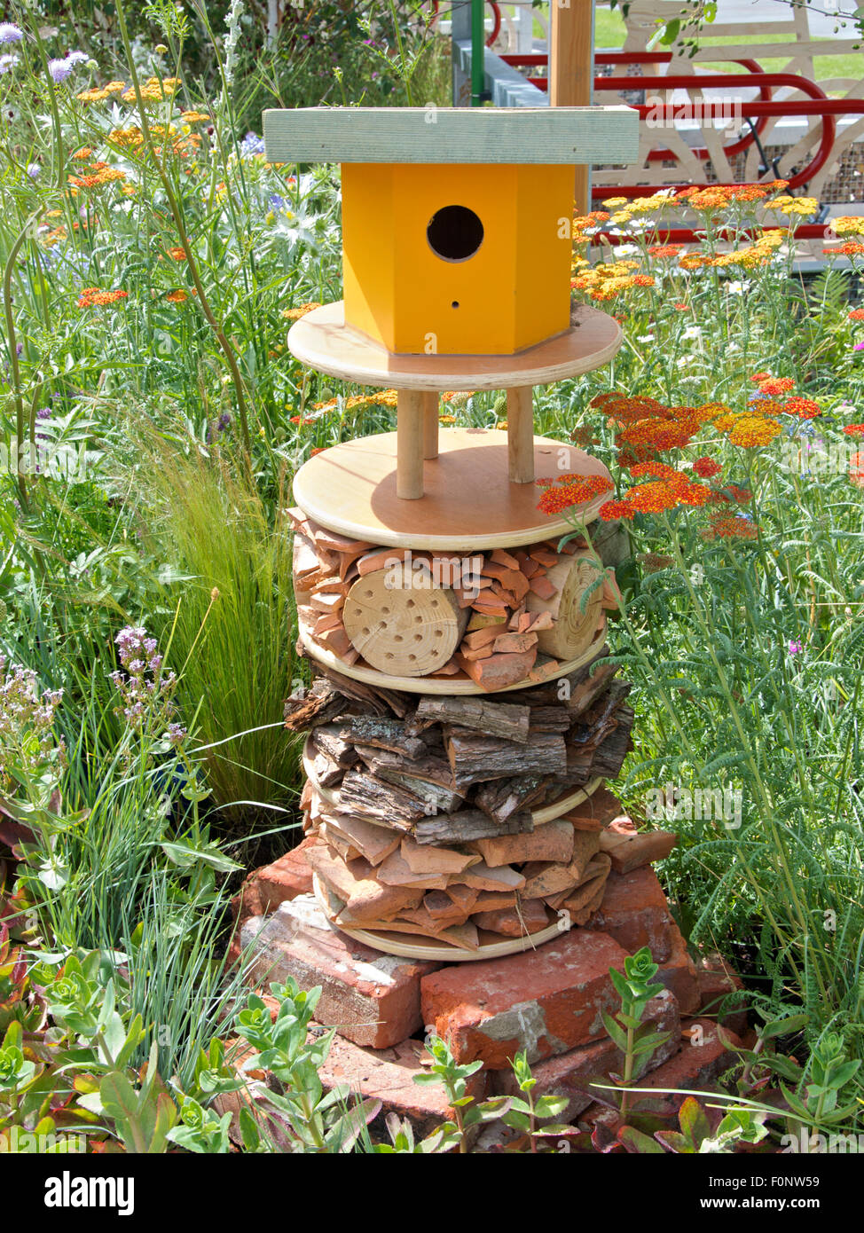 Bird house and insect hotel in a wildlife garden. Stock Photo