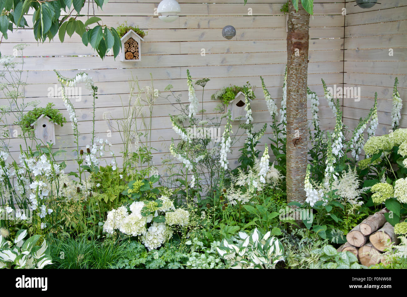 White bird boxes and insect hotel in Living Landscapes: City Twitchers garden at RHS Hampton Court Palace Flower Show 2015 Stock Photo